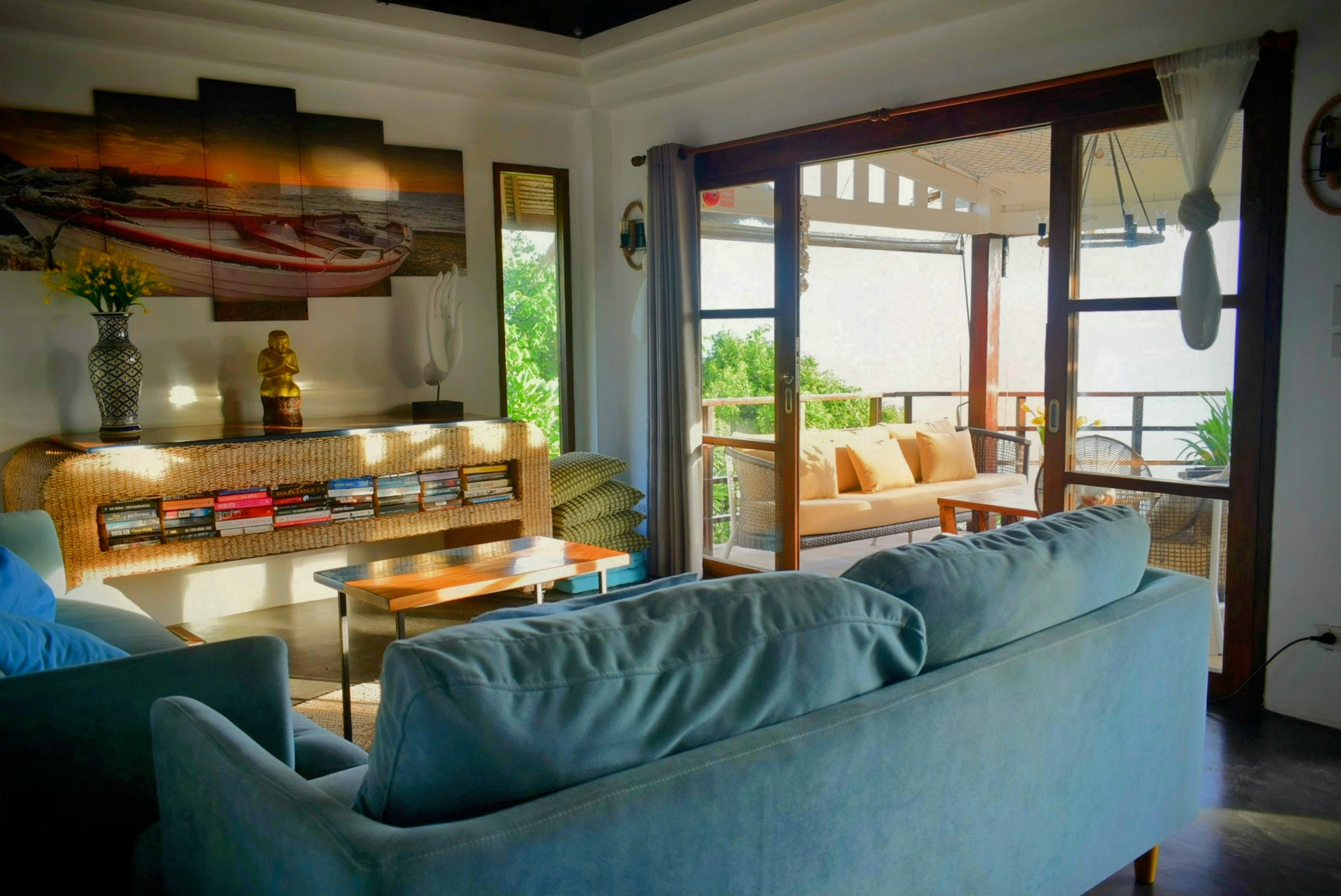 Open living room with sofas opening onto the sea-view terrace at The Fisherman’s House