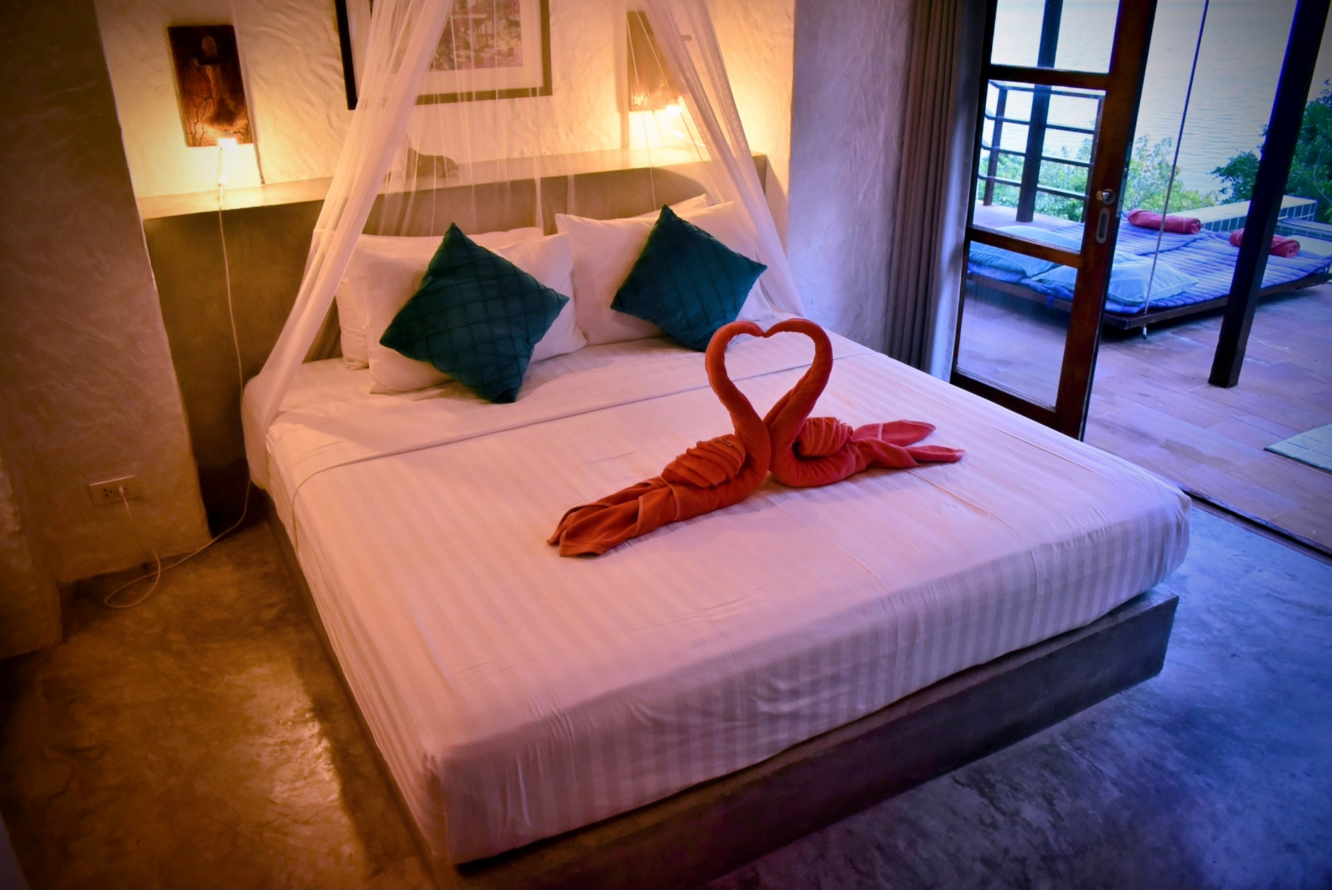 King-size bed with canopy and towel art in The Fisherman's House