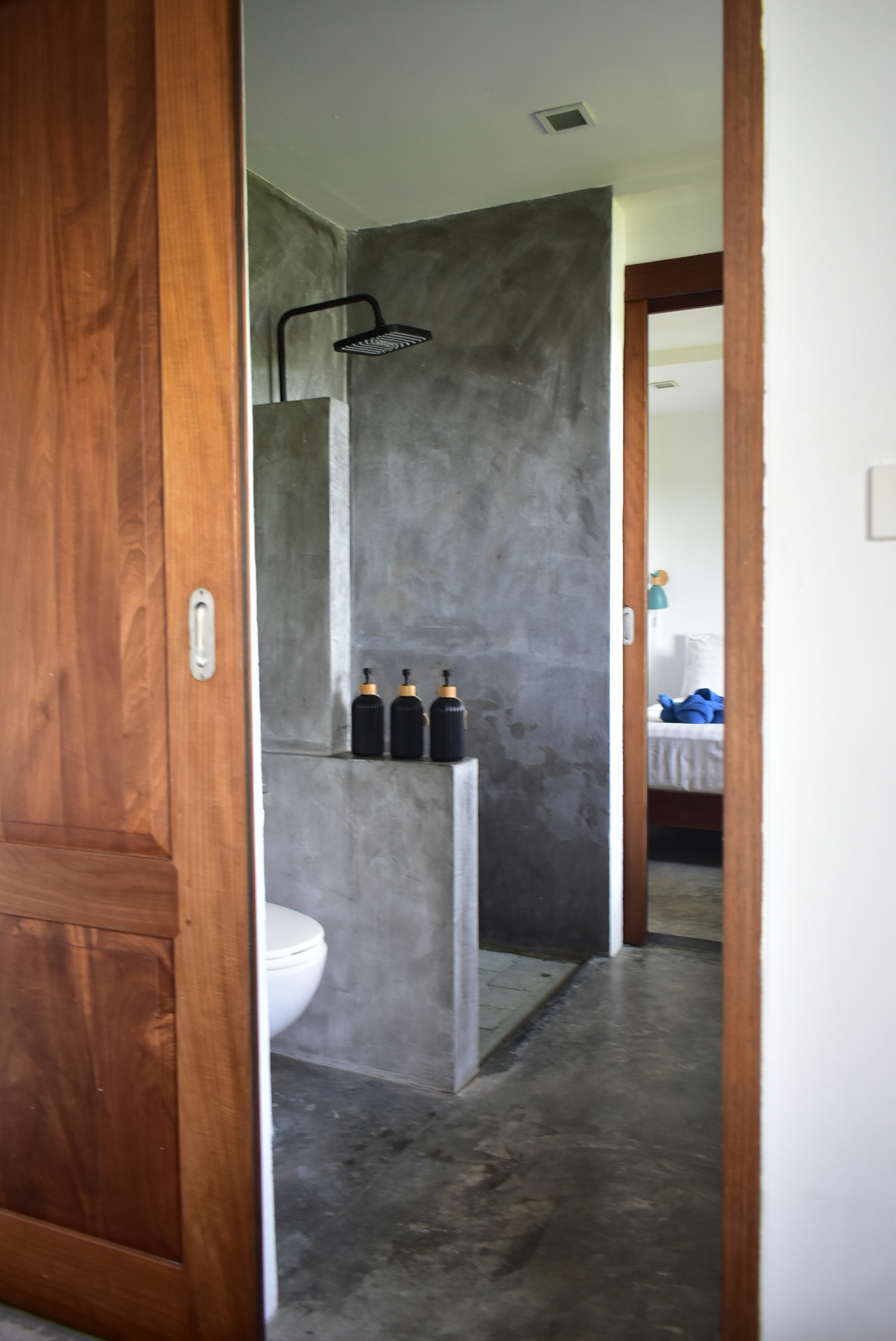 Polished concrete bathroom with rain shower at The Trevally House