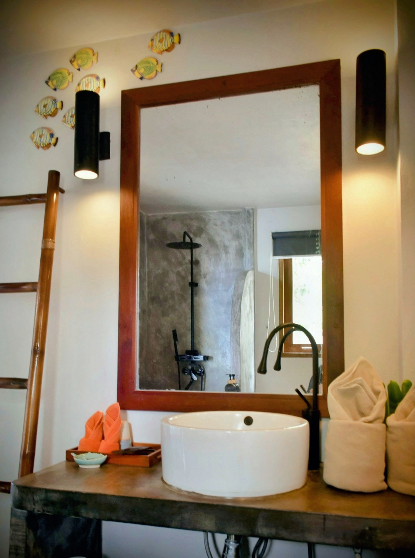 Bathroom with rustic vanity and mirror in The Sailfish House