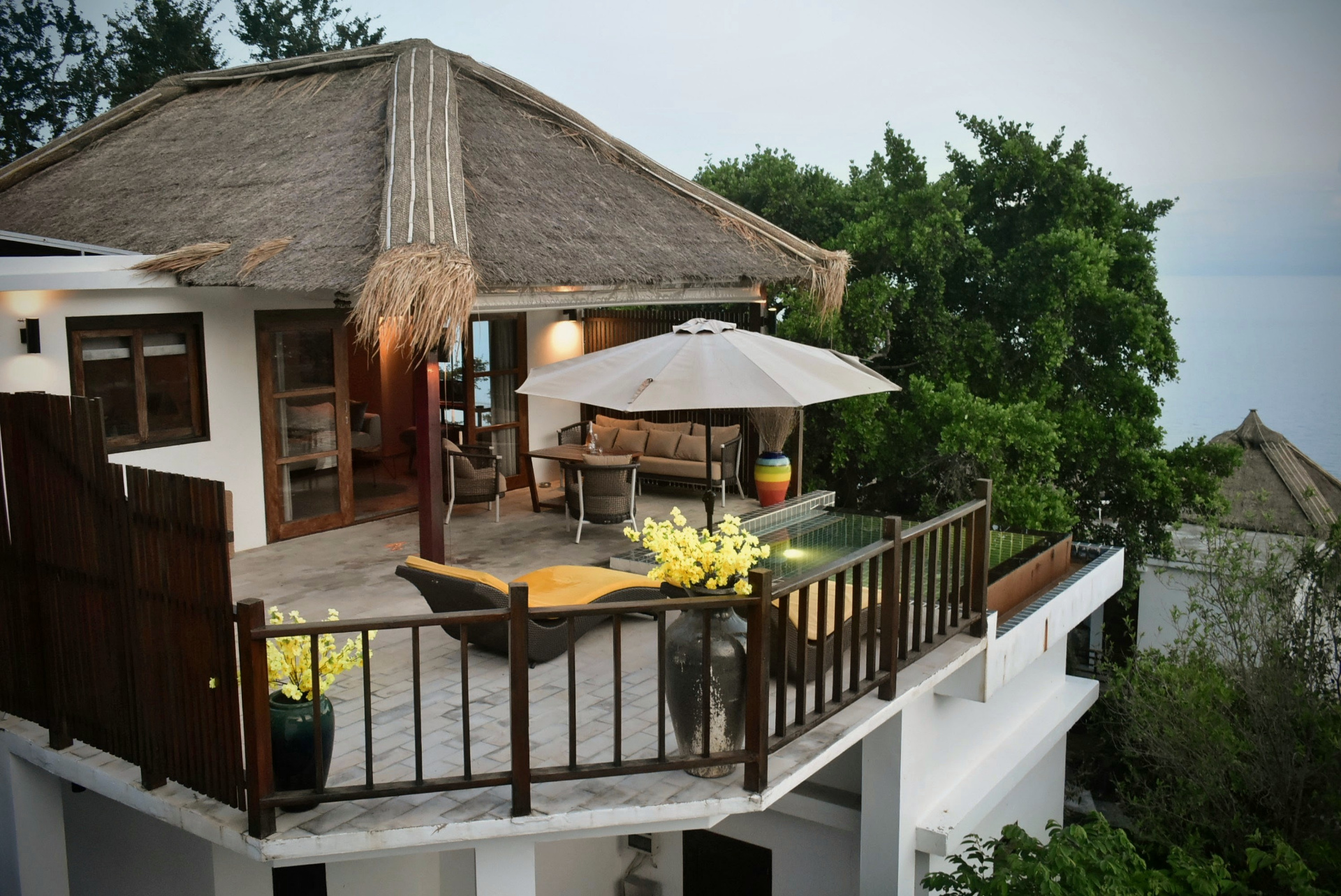 Thatched-roof villa terrace with plunge pool and sea view at The Red Snapper House