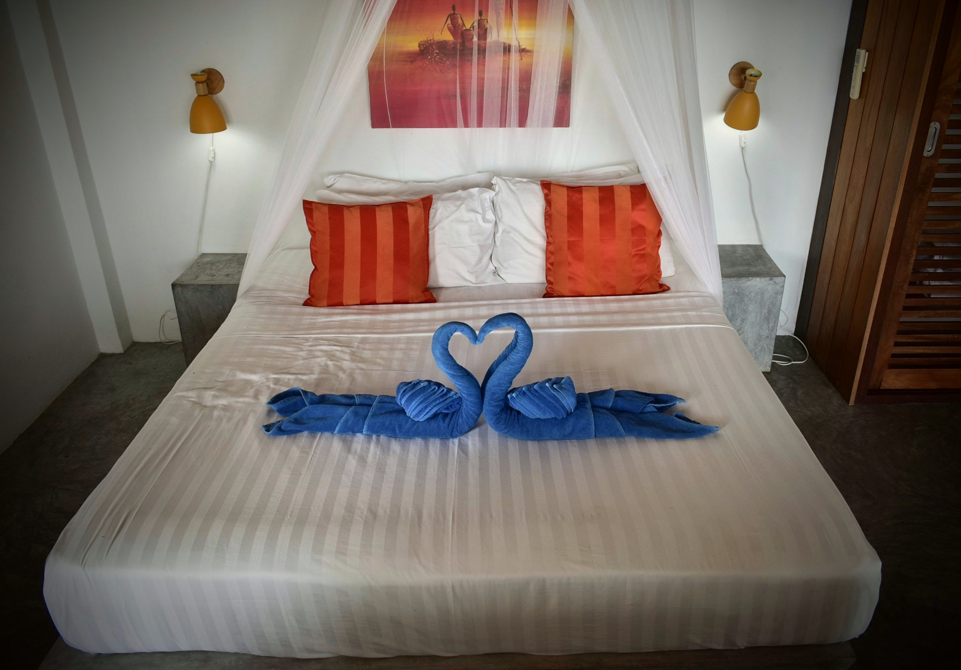 Bedroom with king-size bed and towel art at The Trevally House