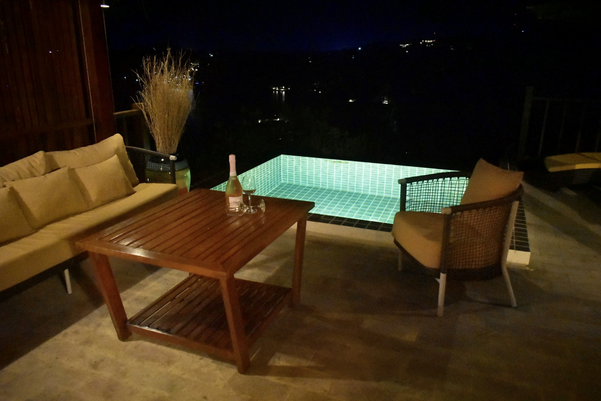Terrace lounge and illuminated pool at night at The Red Snapper House