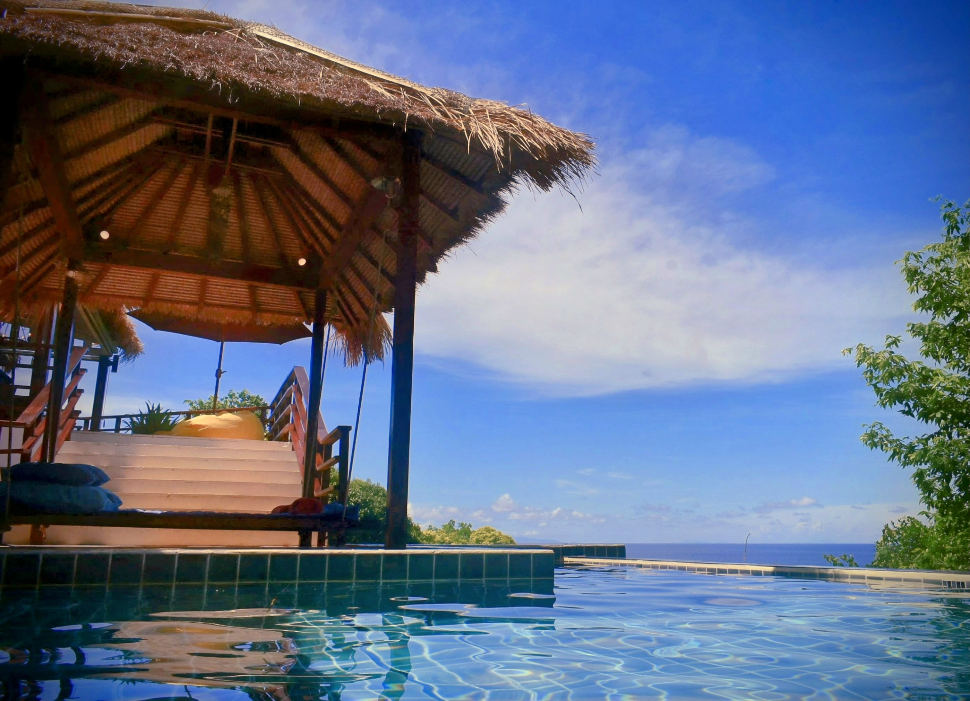 Thatched sala and infinity pool with sea view at The Fisherman’s House