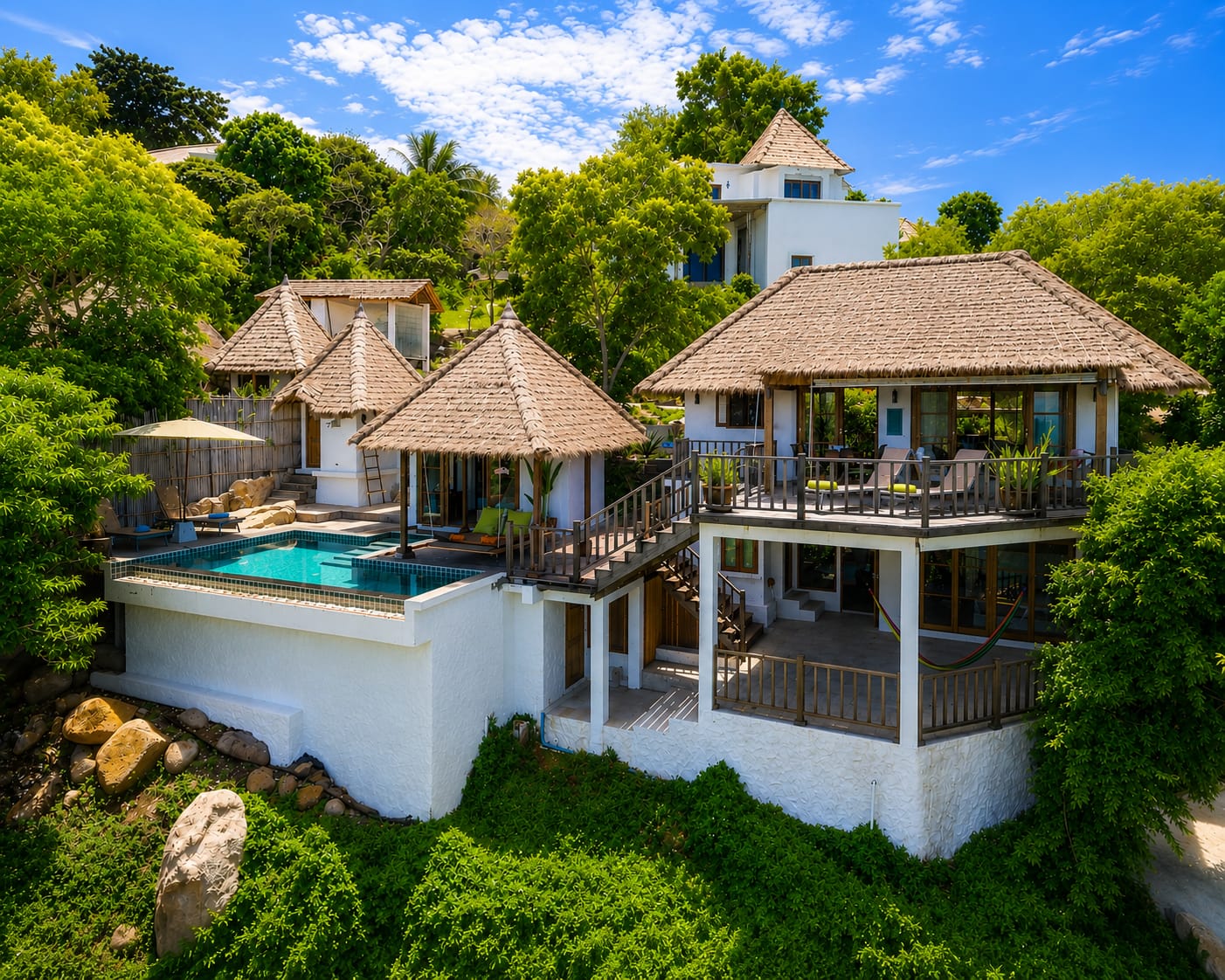 The Fisherman's House villa with private pool, thatched salas and lush tropical garden above Shark Bay