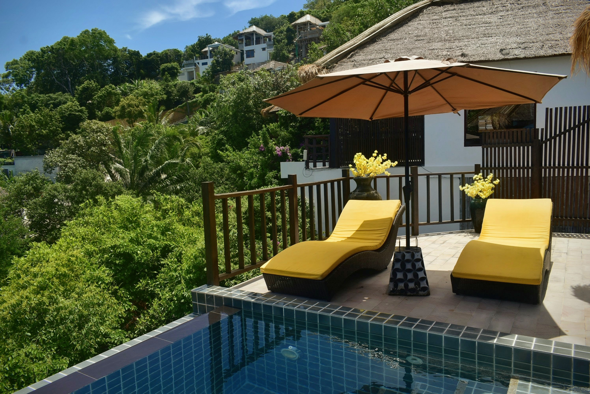 Sun loungers by the pool with hillside views at The Red Snapper House